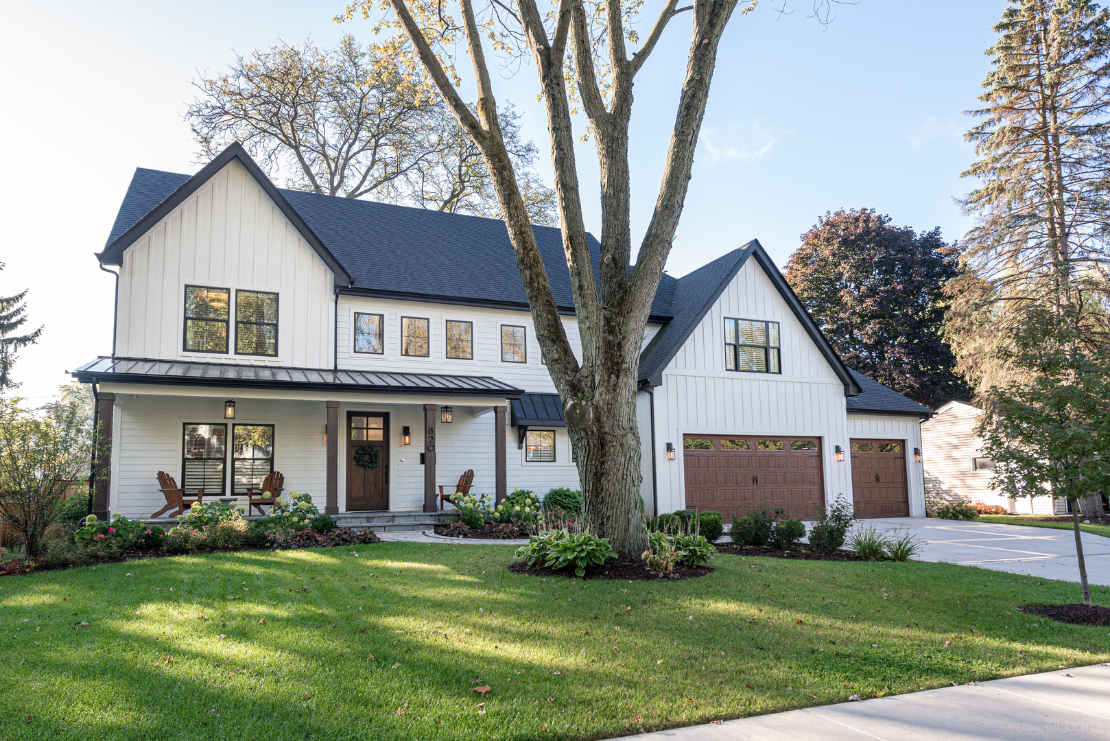 601-1 Harger Road Oak Brook, IL 60523 - Photo 1 of 29 a front view of a house with a garden and trees