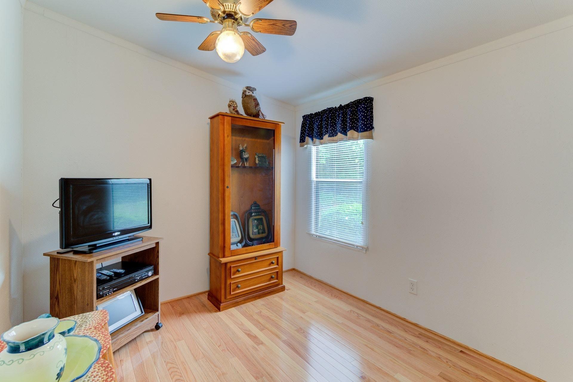 1577 Carroll Road Goodview, VA 24095 - Photo 18 of 40 a bedroom with a bed and a flat screen tv