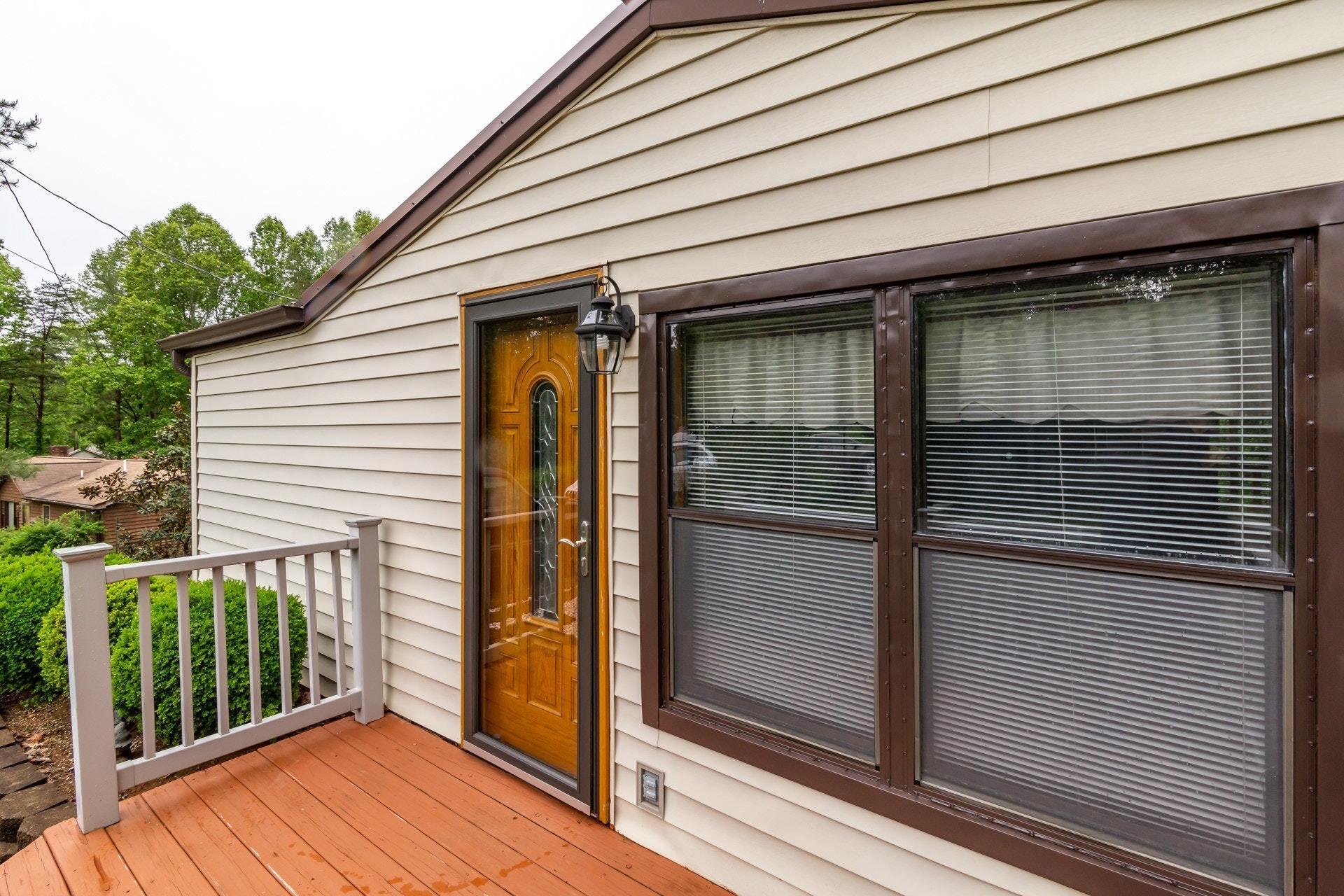 1577 Carroll Road Goodview, VA 24095 - Photo 28 of 40 a yellow house with wooden floor next to a yard