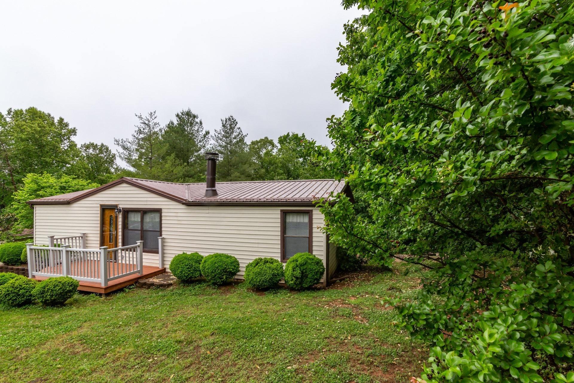 1577 Carroll Road Goodview, VA 24095 - Photo 29 of 40 a front view of a house with a garden