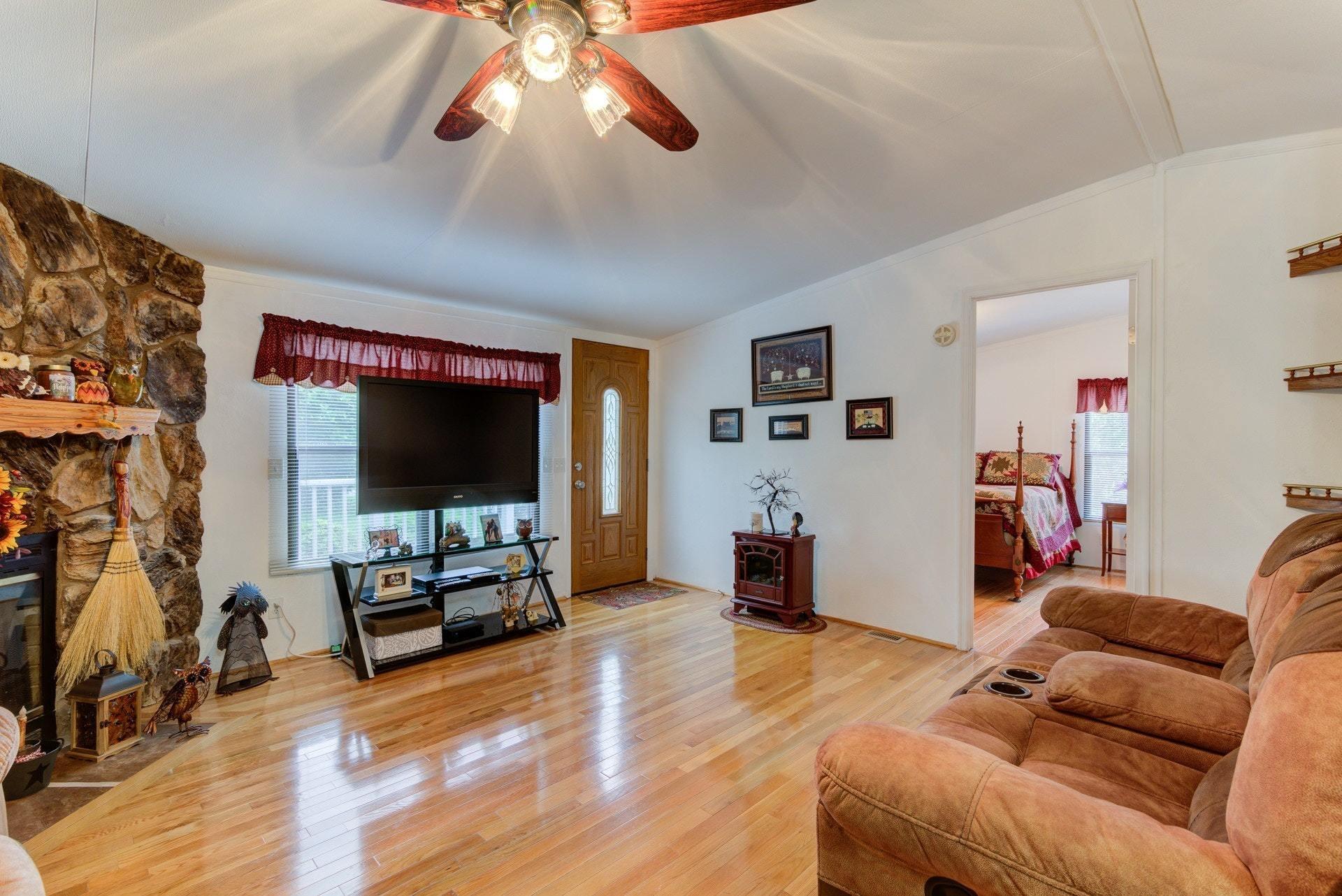 1577 Carroll Road Goodview, VA 24095 - Photo 7 of 40 a living room with furniture and a flat screen tv