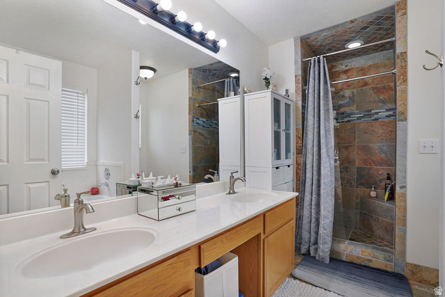 464 West Saddle Back Drive Springville, UT 84663 - Photo 4 of 15 Double vanity with an integrated white countertop, undermount sinks, and brushed nickel faucets