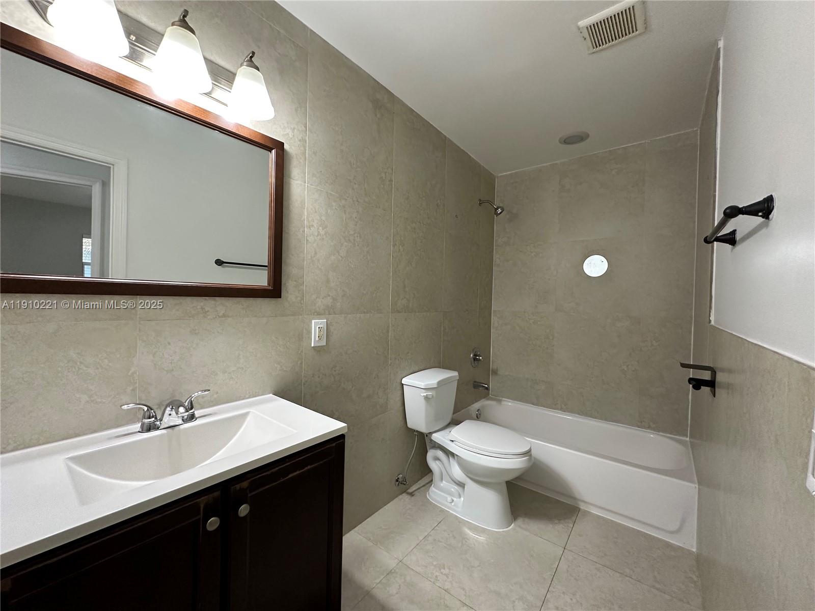 2640 Northeast 8th Avenue, Unit 13 Wilton Manors, FL 33334 - Photo 20 of 34 a bathroom with a sink toilet and mirror