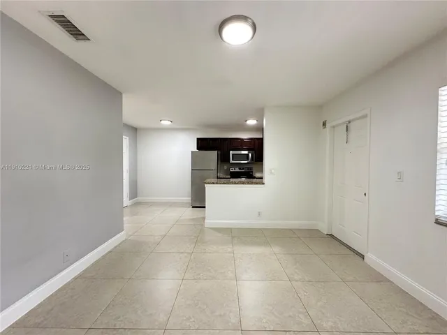 a view of a kitchen with a sink and a stove top oven