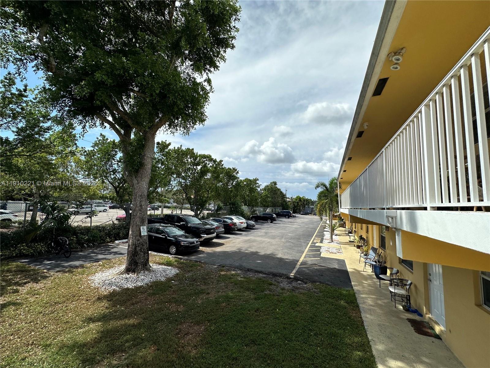 2640 Northeast 8th Avenue, Unit 13 Wilton Manors, FL 33334 - Photo 31 of 34 a view of swimming pool with lawn chairs and iron fence