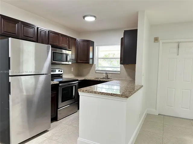 a kitchen with a refrigerator sink and stove