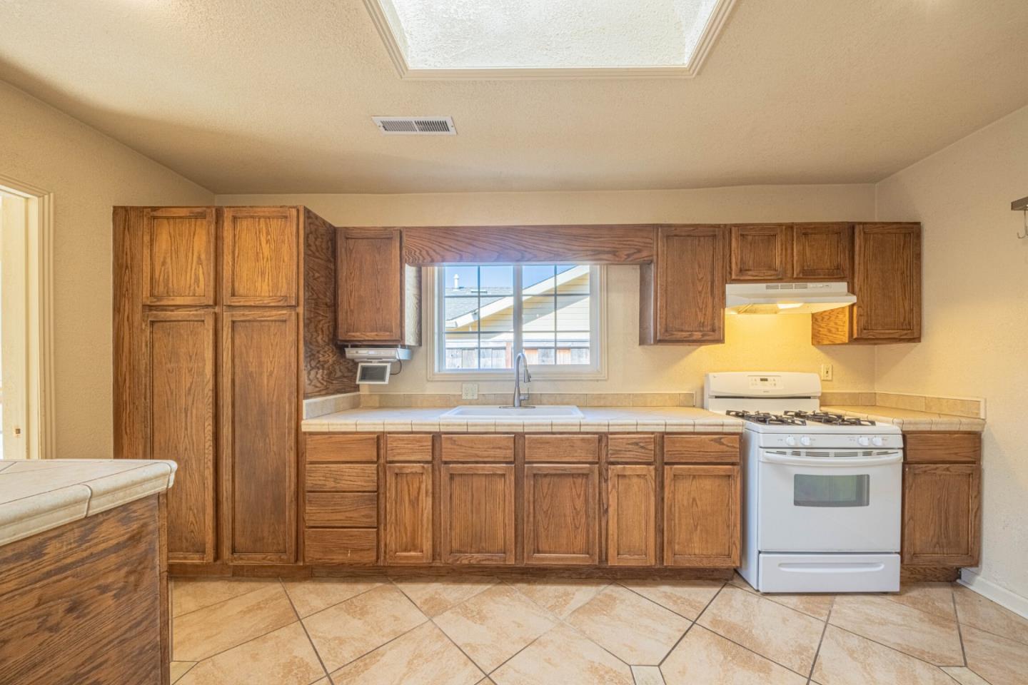 40 Oak Street Salinas, CA 93901 - Photo 11 of 28 a kitchen with a stove sink and cabinets