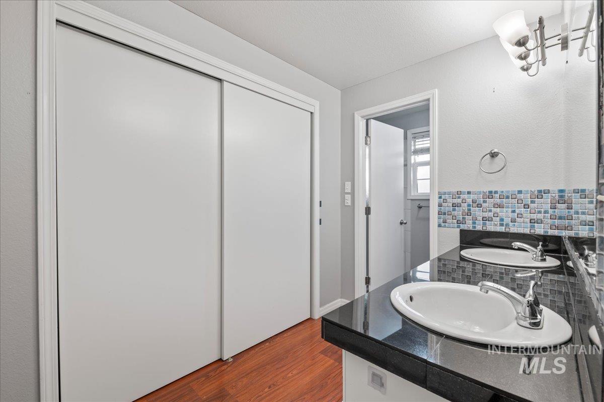 11457 Alejandro Street Boise, ID 83709 - Photo 19 of 42 Bathroom with vanity, dark wood-type flooring, and a textured ceiling