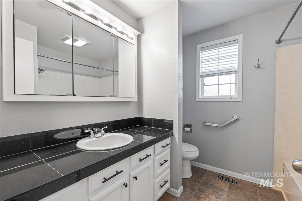 11457 Alejandro Street Boise, ID 83709 - Photo 25 of 42 Full bathroom featuring vanity and washtub / shower combination