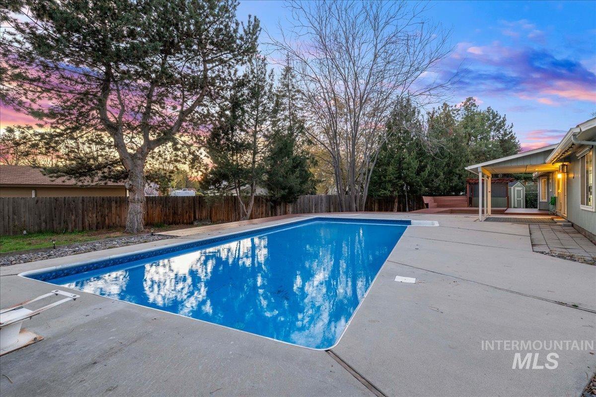 11457 Alejandro Street Boise, ID 83709 - Photo 33 of 42 Pool at dusk with a fenced backyard and a patio