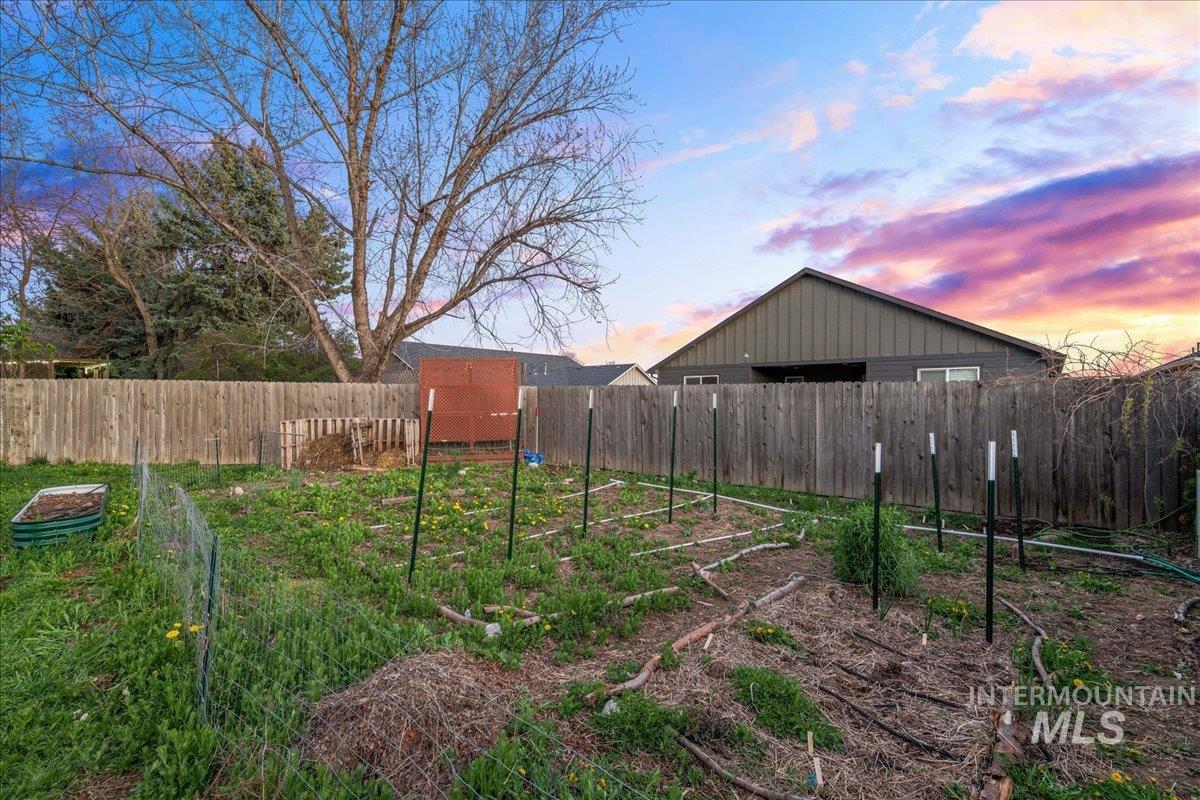 11457 Alejandro Street Boise, ID 83709 - Photo 35 of 42 Fenced backyard with a vegetable garden