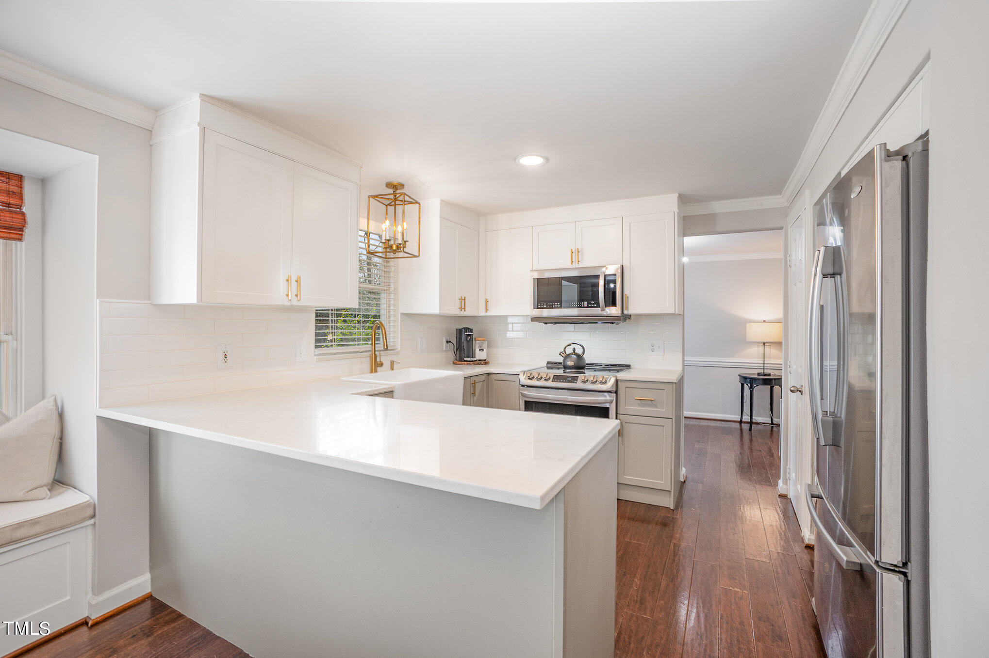 4324 Hickory Ridge Drive Raleigh, NC 27609 - Photo 14 of 34 a kitchen with stainless steel appliances a sink a stove a refrigerator cabinets and a window
