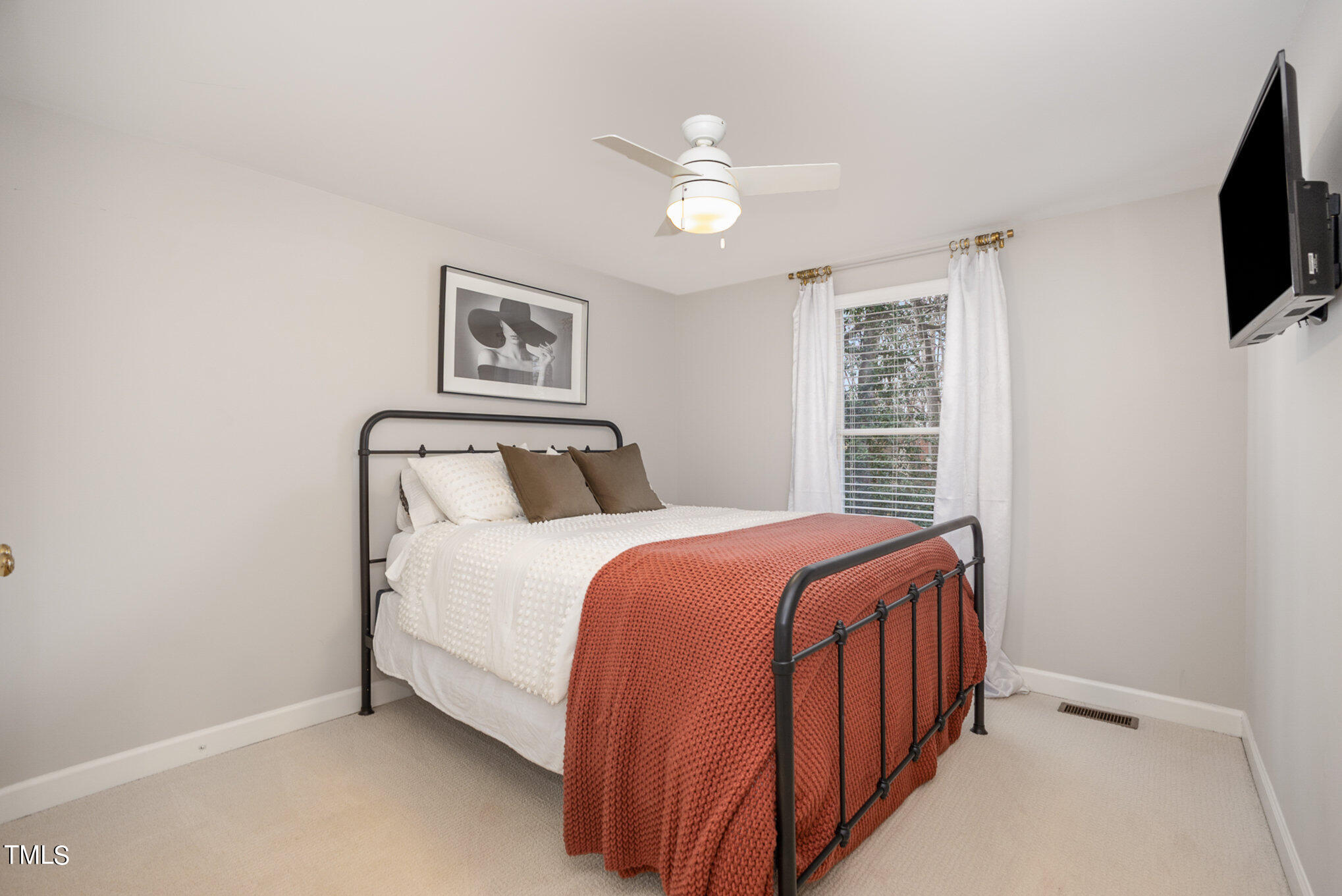 4324 Hickory Ridge Drive Raleigh, NC 27609 - Photo 24 of 34 a bedroom with a bed and a flat screen tv
