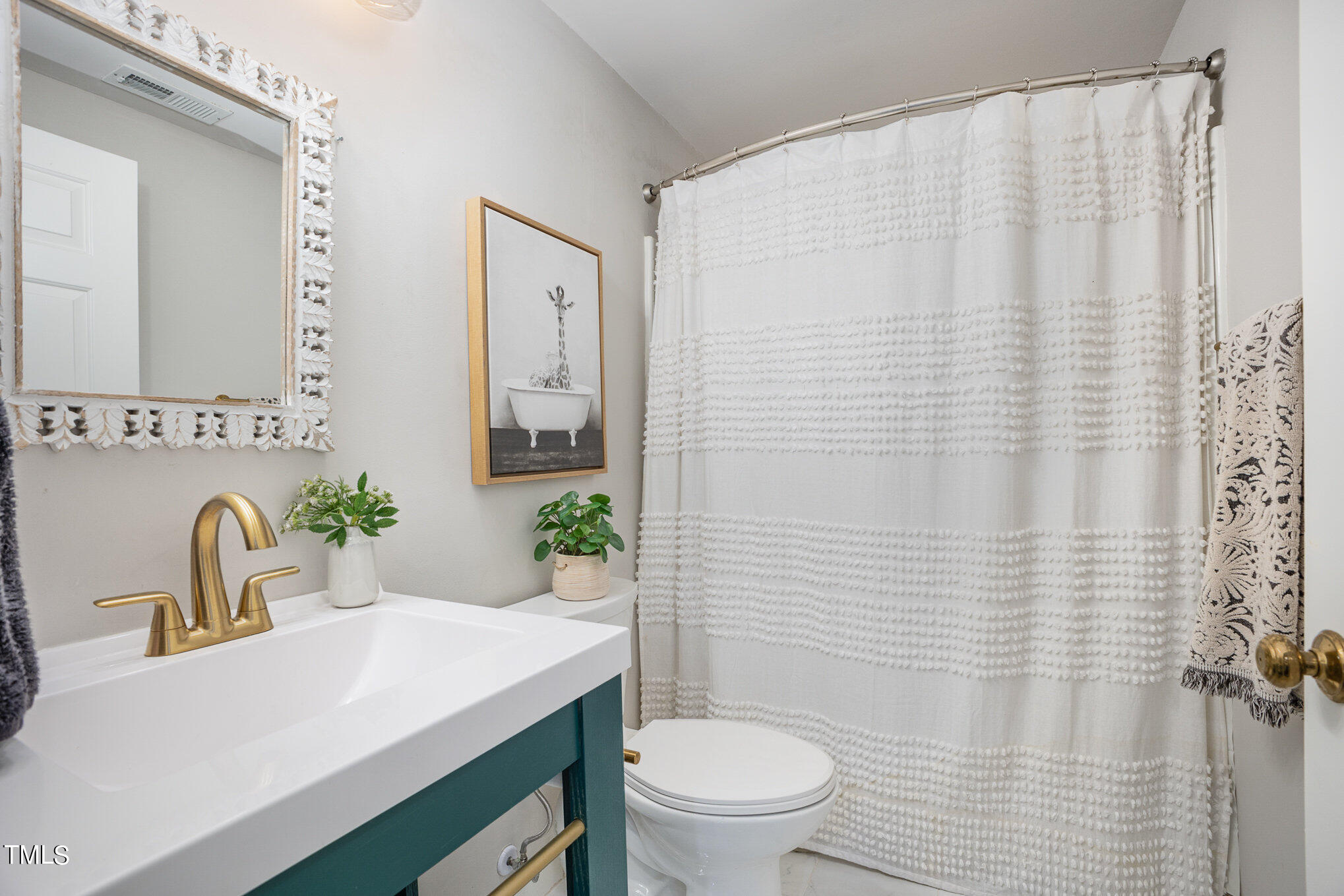 4324 Hickory Ridge Drive Raleigh, NC 27609 - Photo 25 of 34 a bathroom with a sink a toilet and shower curtain
