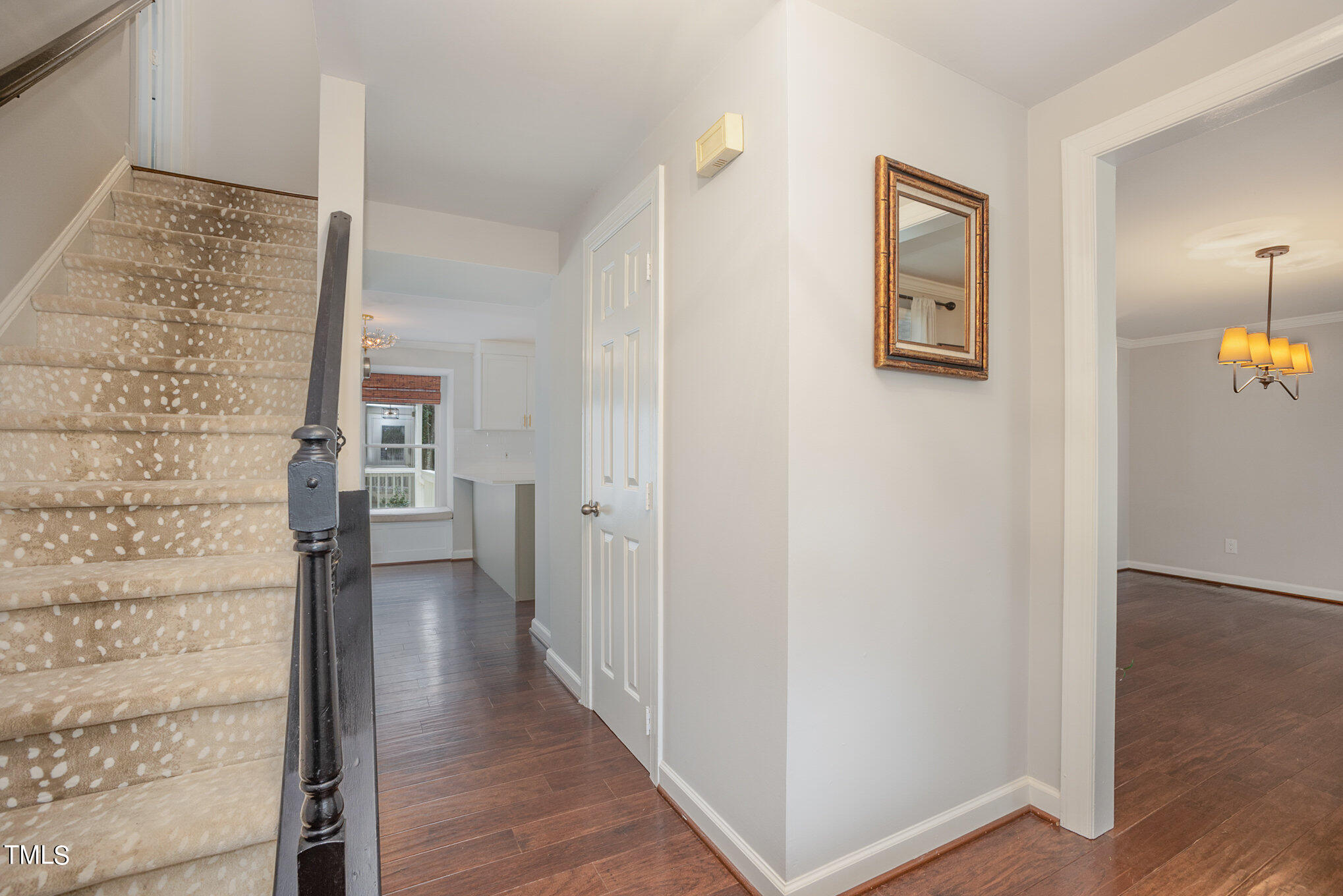 4324 Hickory Ridge Drive Raleigh, NC 27609 - Photo 8 of 34 a view of a hallway with wooden floor and a bathroom