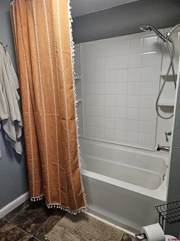a bathroom with bathtub and shower