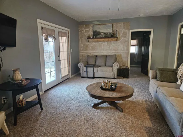 a living room with furniture a flat screen tv and a fireplace
