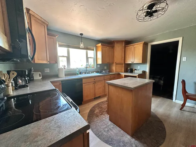 a kitchen with a sink stove and refrigerator