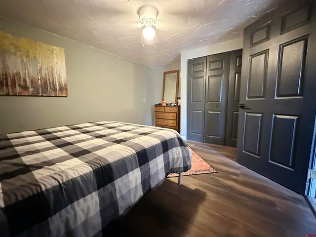 a bedroom with a large bed and a chandelier