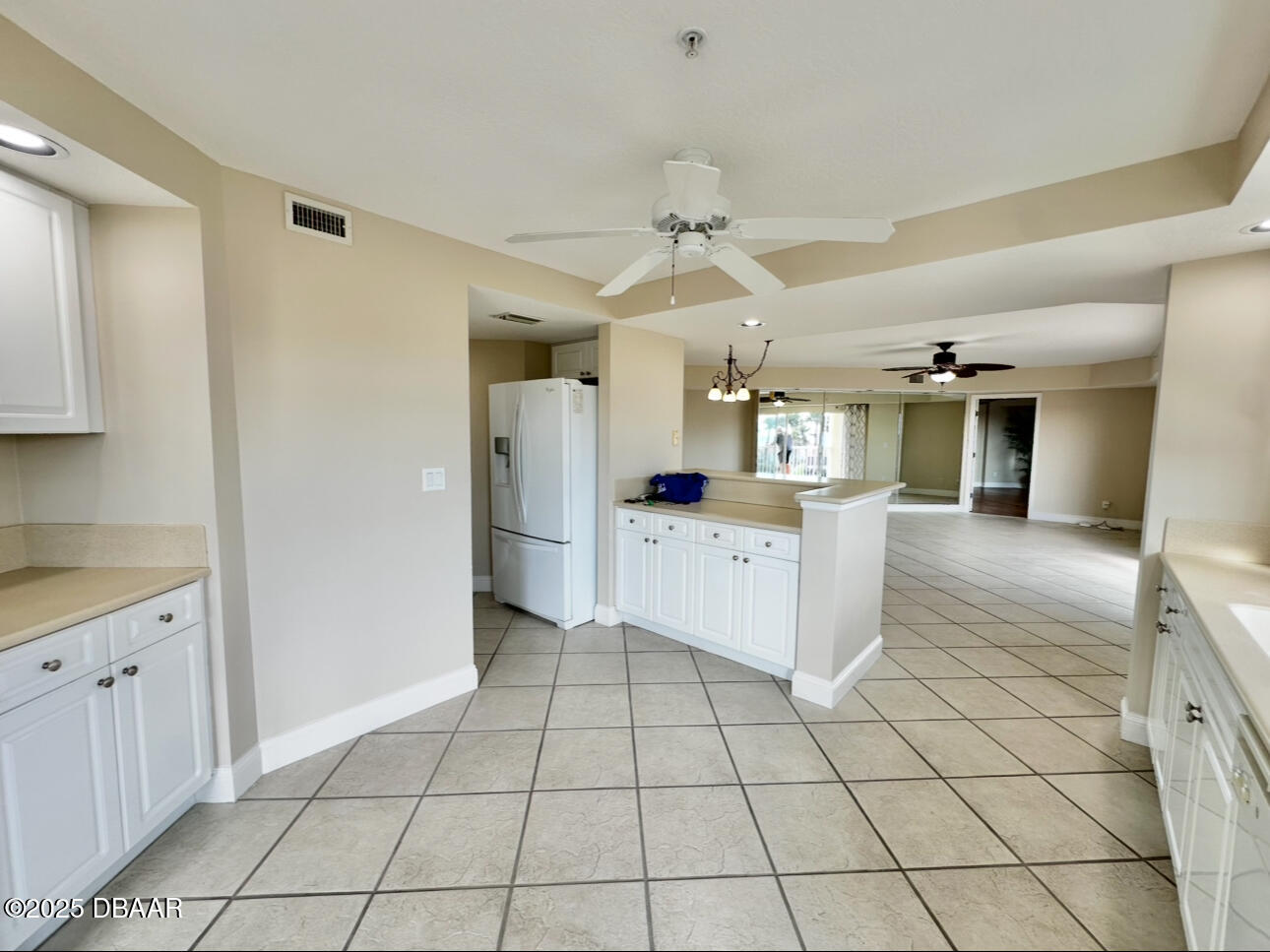 4670 Links Village Drive, Unit C404 Ponce Inlet, FL 32127 - Photo 12 of 41 a kitchen with stainless steel appliances kitchen island granite countertop a refrigerator and a sink