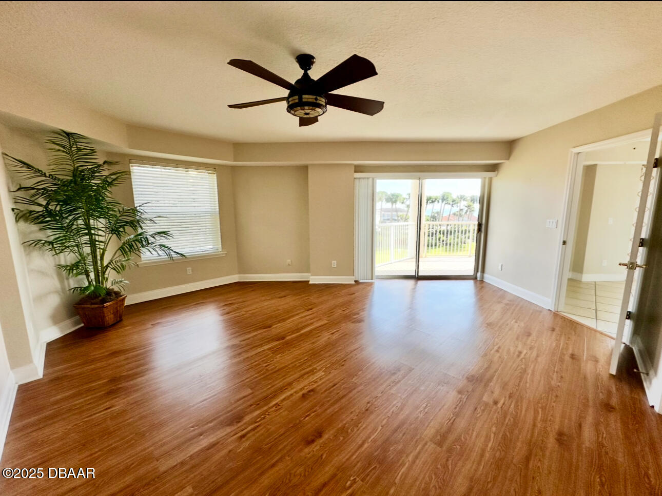 4670 Links Village Drive, Unit C404 Ponce Inlet, FL 32127 - Photo 15 of 41 a view of a livingroom with wooden floor and a ceiling fan