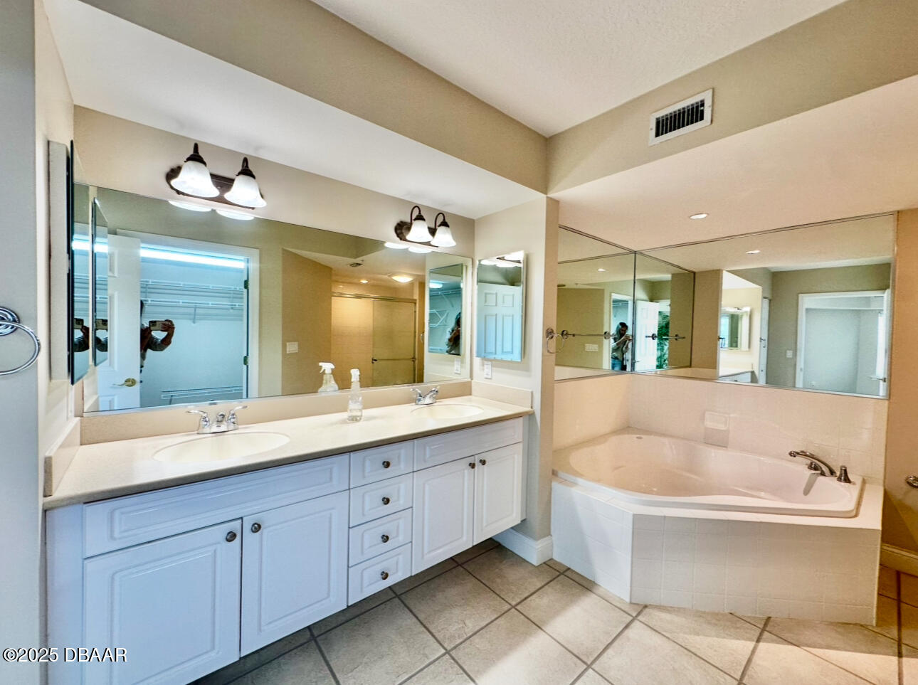 4670 Links Village Drive, Unit C404 Ponce Inlet, FL 32127 - Photo 17 of 41 a spacious bathroom with a double vanity sink mirror and bathtub