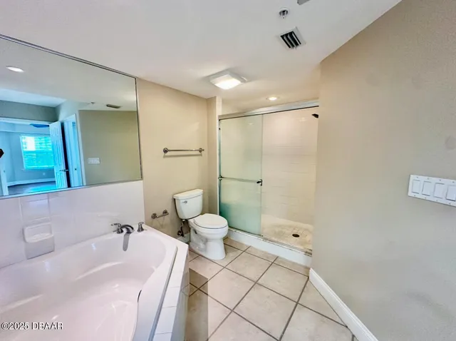 a spacious bathroom with a granite countertop sink mirror and bathtub
