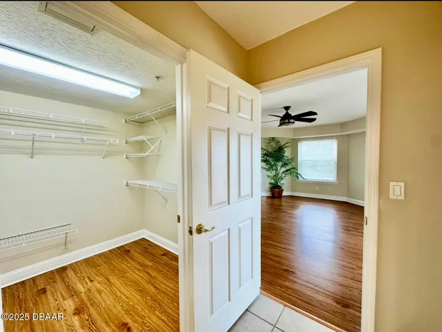 a view of a bathroom with a bathtub a ceiling fan and windows