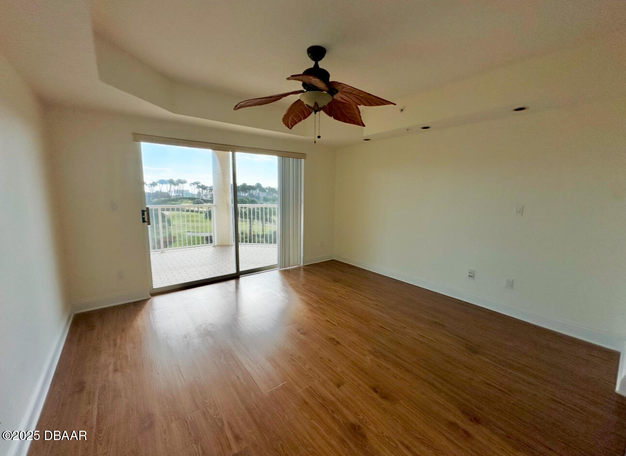 4670 Links Village Drive, Unit C404 Ponce Inlet, FL 32127 - Photo 27 of 41 a view of empty room with wooden floor and fan