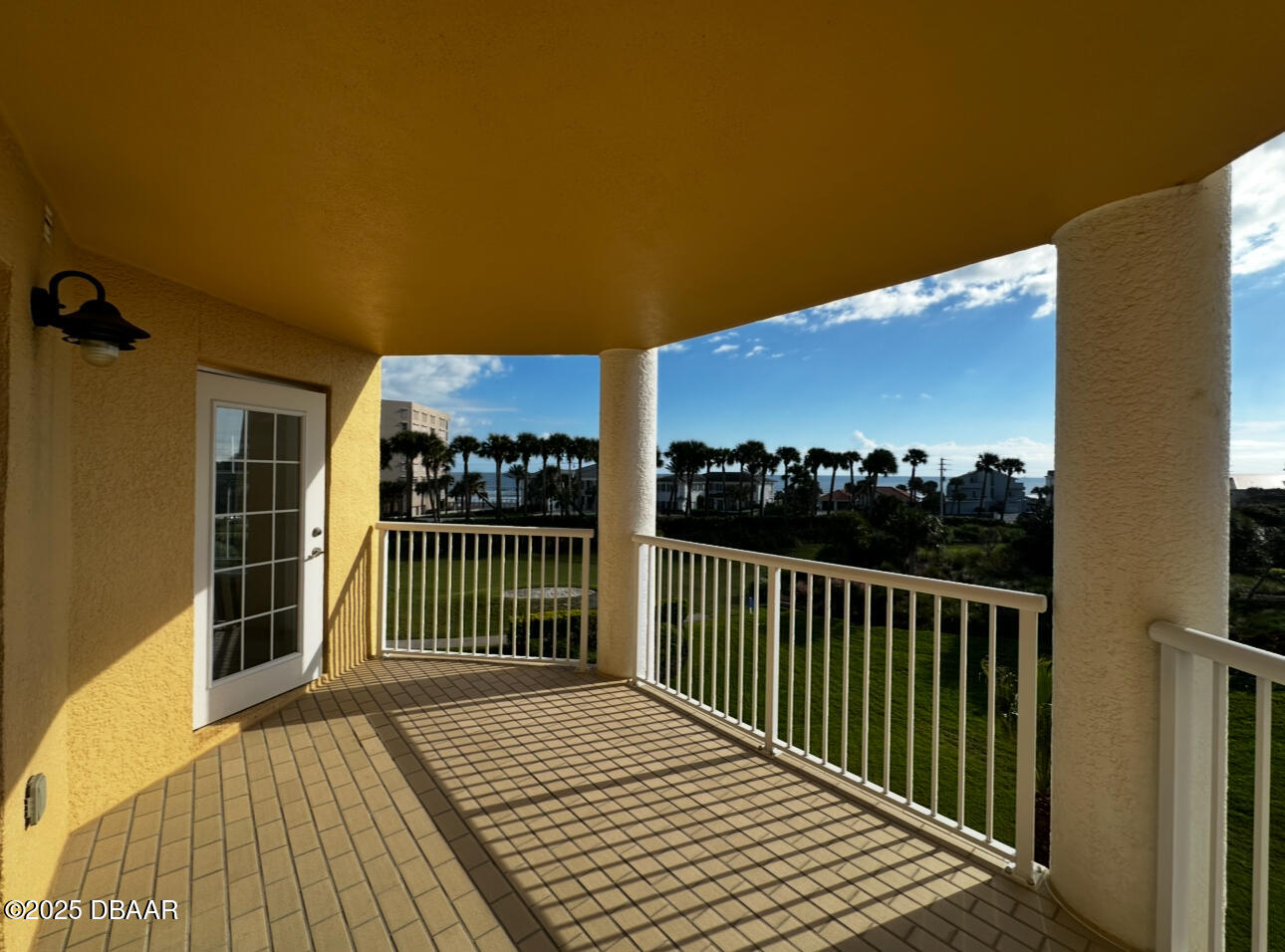 4670 Links Village Drive, Unit C404 Ponce Inlet, FL 32127 - Photo 28 of 41 a view of a balcony with wooden floor