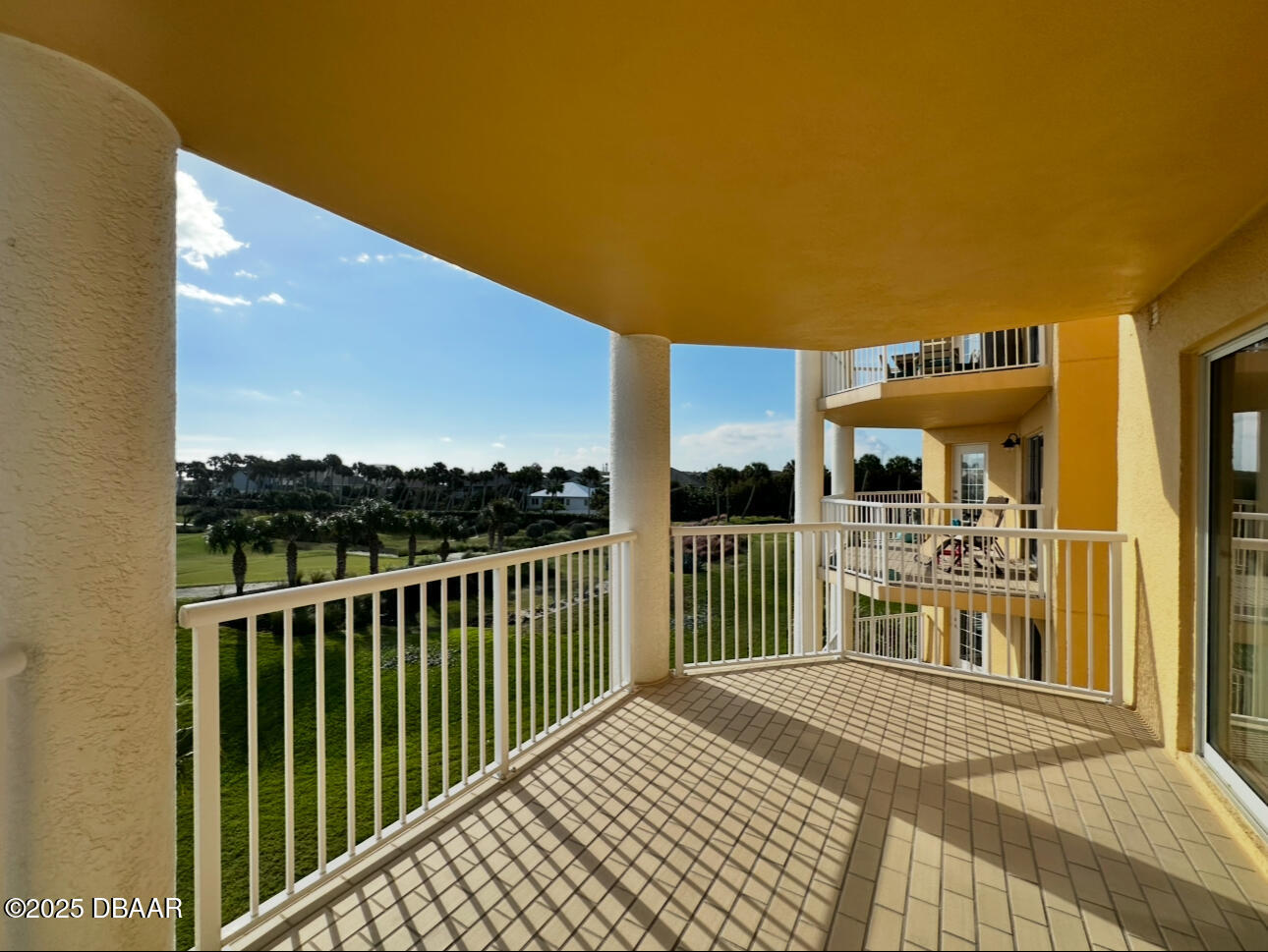 4670 Links Village Drive, Unit C404 Ponce Inlet, FL 32127 - Photo 30 of 41 a view of a balcony with wooden floor