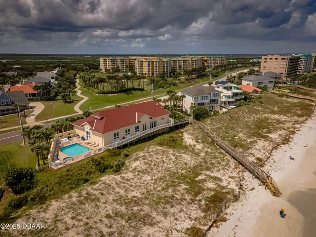 an aerial view of a house with garden space and street view