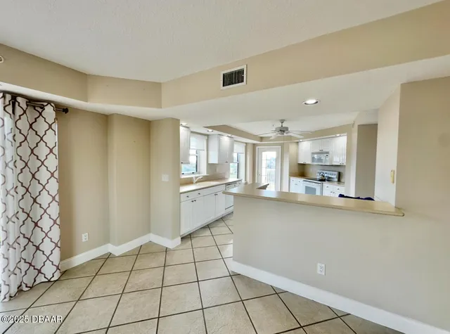 a kitchen with a sink a stove cabinets and counter space
