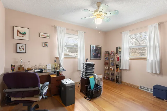 a view of a workspace with furniture and a window