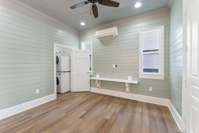 a view of walk in closet with wooden floor