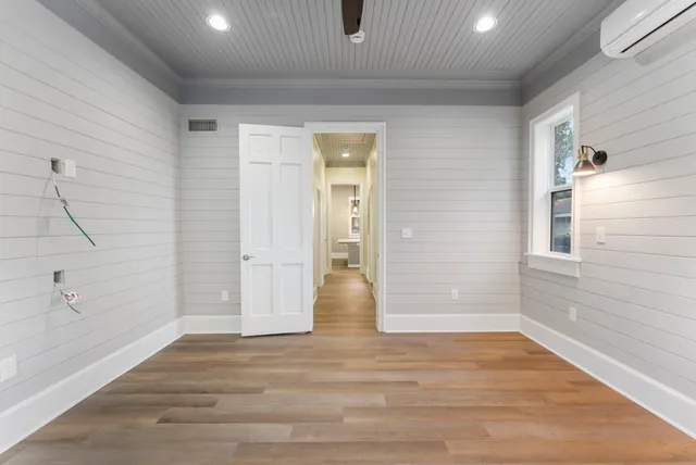 wooden floor in an empty room with a window