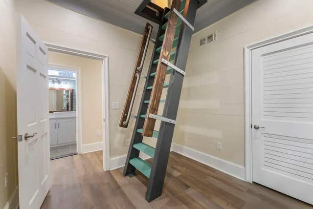 a view of a livingroom with a window and wooden floor