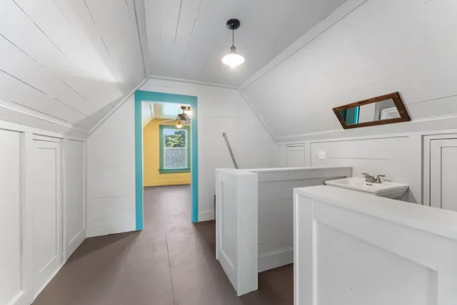 a bathroom with a sink mirror and toilet