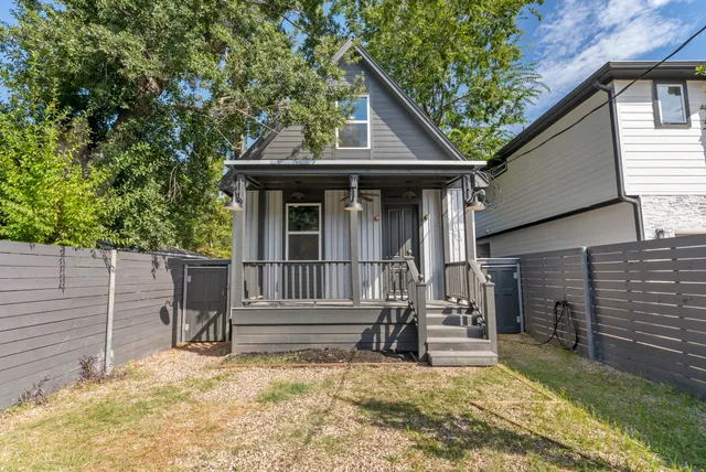 a view of house with backyard and sitting area