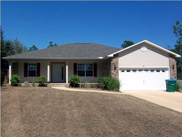 435 Ridge Lake Road Crestview, FL 32536 - Photo 1 of 16 a front view of a house with a garden and yard