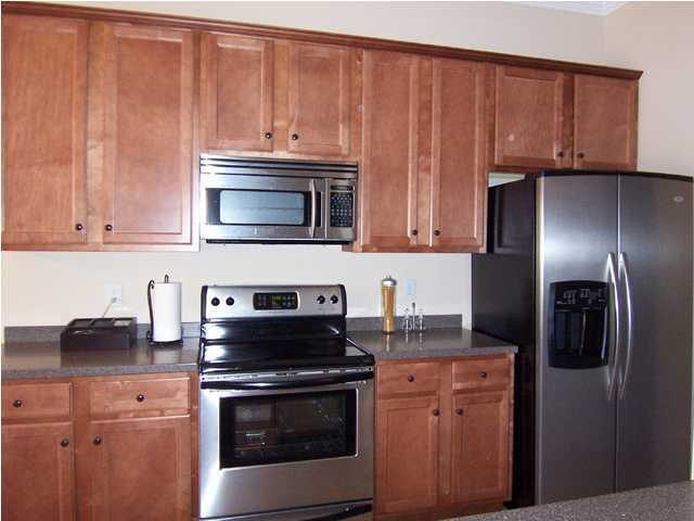 435 Ridge Lake Road Crestview, FL 32536 - Photo 6 of 16 a kitchen with granite countertop wooden cabinets and stainless steel appliances