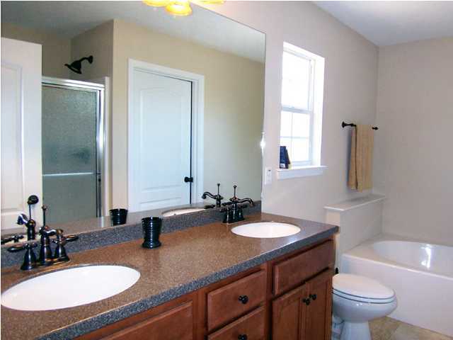 435 Ridge Lake Road Crestview, FL 32536 - Photo 7 of 16 a bathroom with double vanity sinks a toilet a mirror and a window