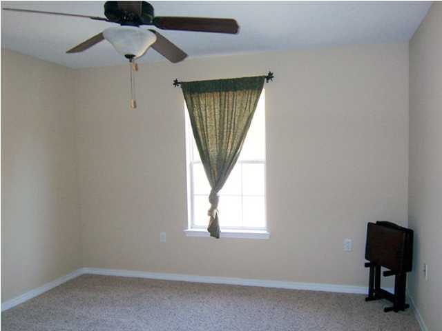 435 Ridge Lake Road Crestview, FL 32536 - Photo 8 of 16 an empty room with windows and fan