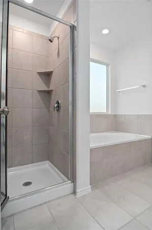 a bathroom with a shower and a tub
