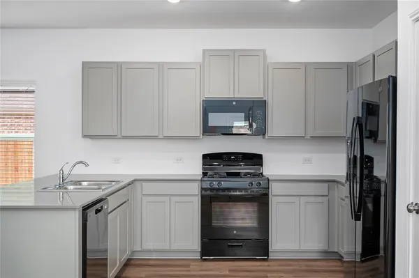 a kitchen with a sink stove and refrigerator