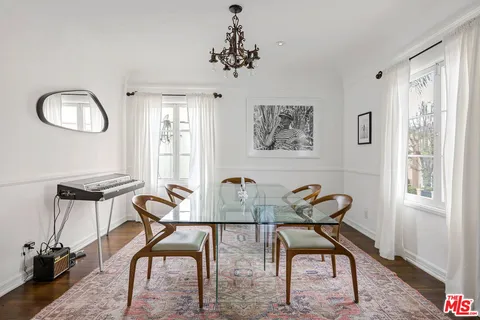 a view of a workspace room with furniture window and wooden floor