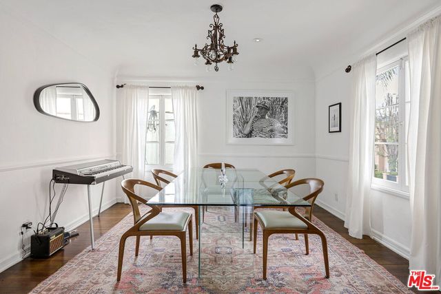 a view of a workspace room with furniture window and wooden floor