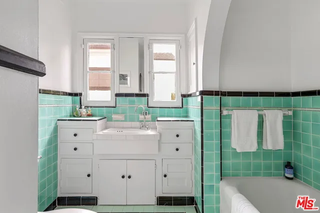 a bathroom with a double vanity sink and a bathtub