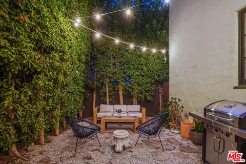 a backyard of a house with table and chairs