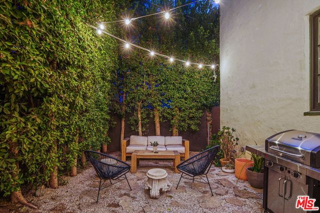 a backyard of a house with table and chairs